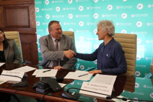 JWCC President Dr. Bryan Renfro and Illinois College President Dr. Barbara Farley shake hands after signing articulation agreements in accounting, business management, and sports management.