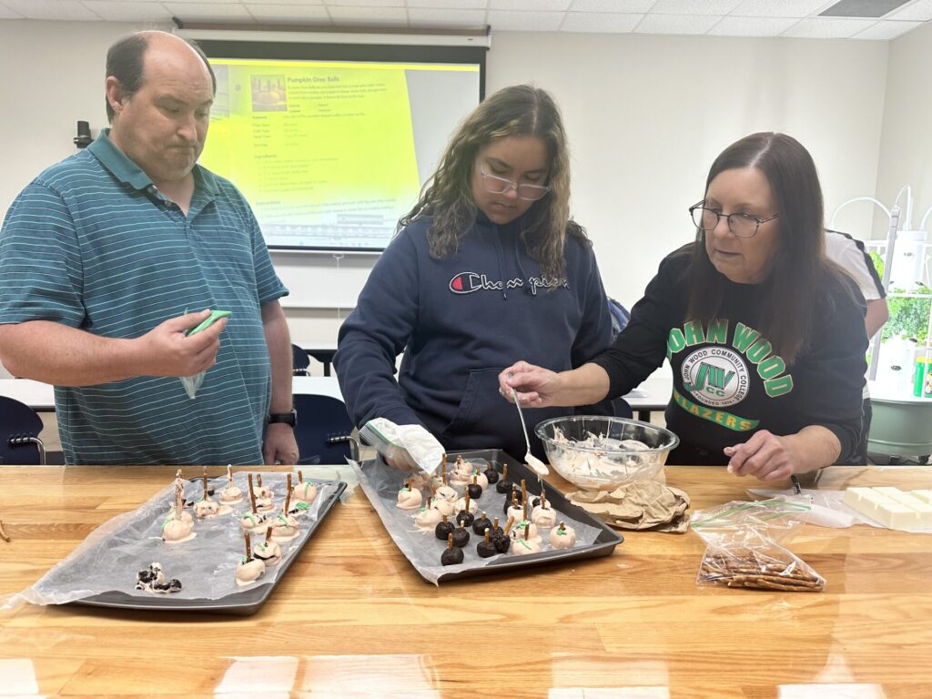 College for Life instructor guides student in baking